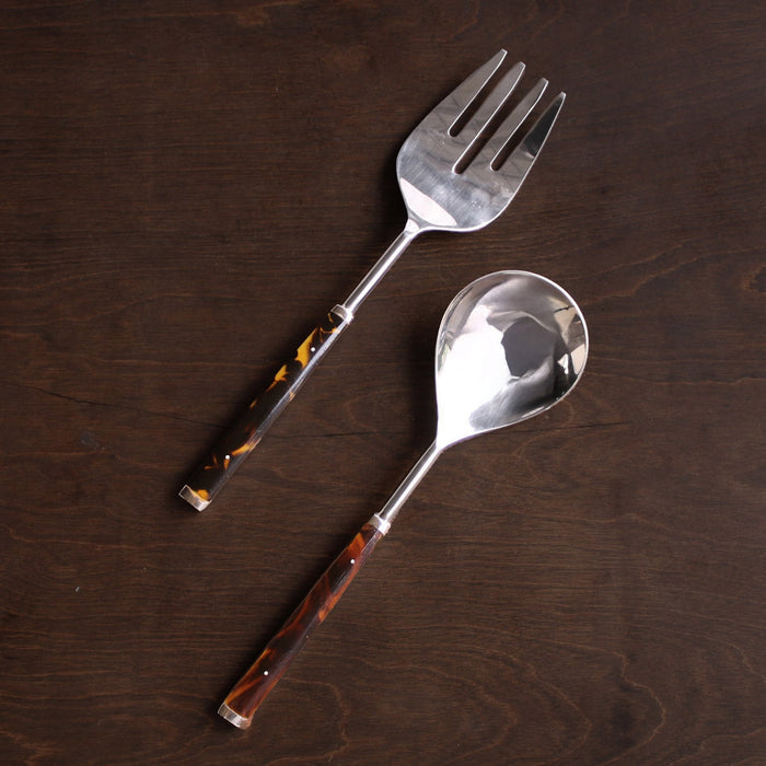 Beatriz Ball Vida Tortoise and Stainless Salad Servers — Paired utensils on a dark wooden surface