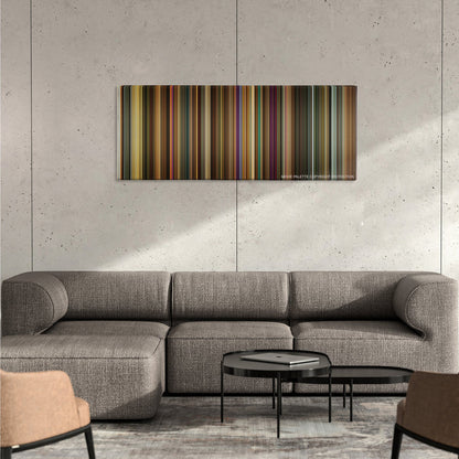 Across the Universe color palette canvas on a concrete wall above a gray sectional sofa