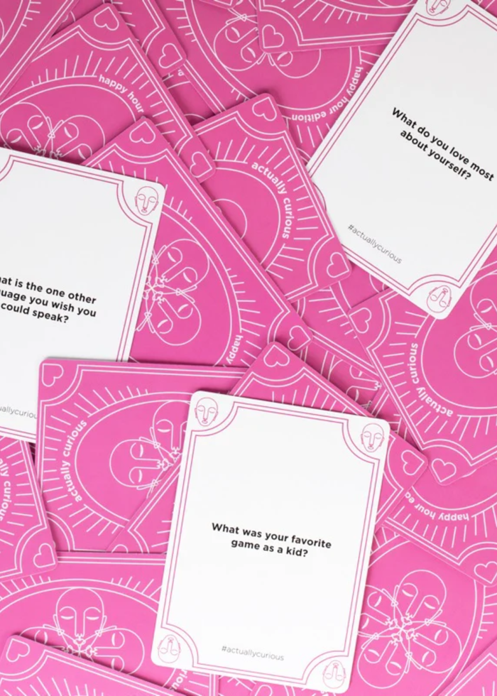 White cards with a question laying on top of pink cards