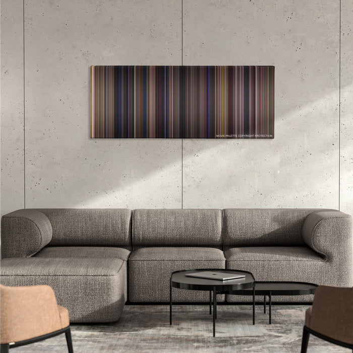Almost Famous color palette canvas on a concrete wall above a gray sectional sofa