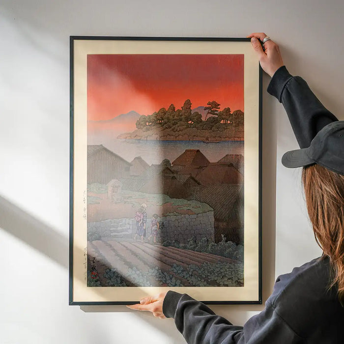 Amakusa Print by Hasui Kawase being hung on a wall in a black frame