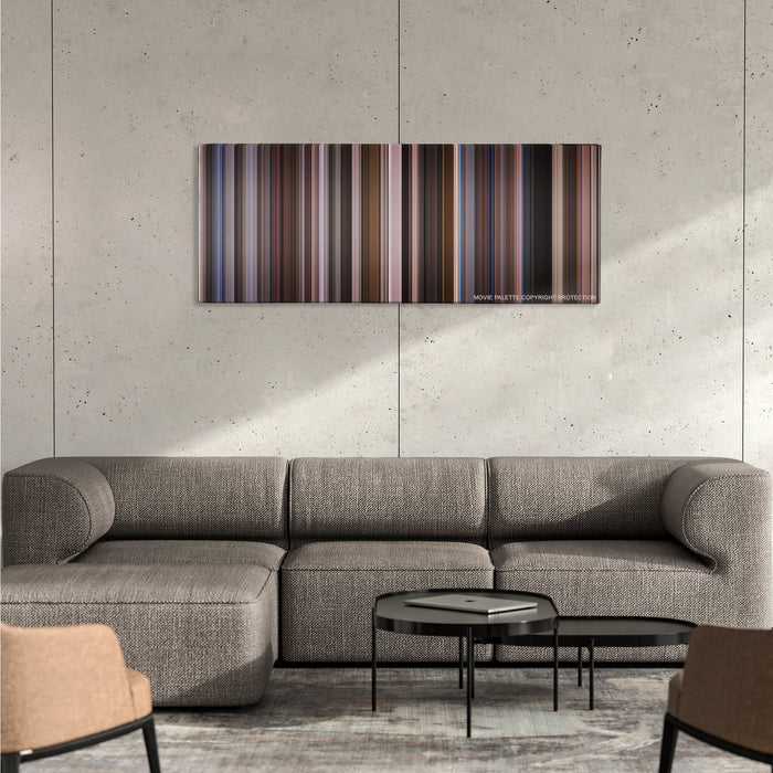 An Education color palette canvas on a concrete wall above a gray sectional sofa