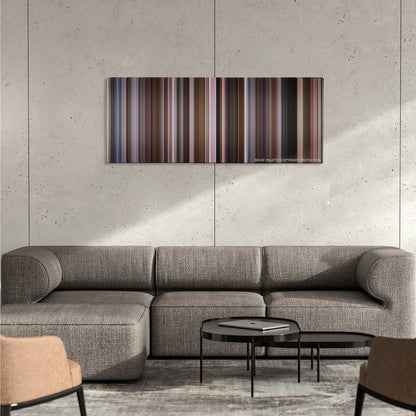 An Education color palette canvas on a concrete wall above a gray sectional sofa