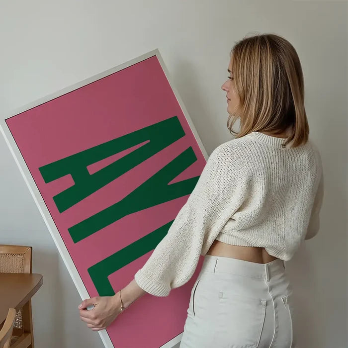 Aye Pink Typography Poster Print held up against a living room wall