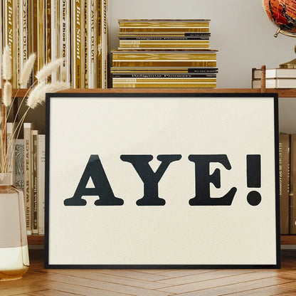 Aye Typography Poster Print framed on a living room bookshelf
