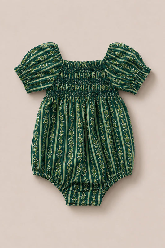 The Ivy City Co Baby Sunday Best Romper in Pine Felicity Floral features short puffed sleeves, a smocked chest, and vertical floral stripes on a beige background.