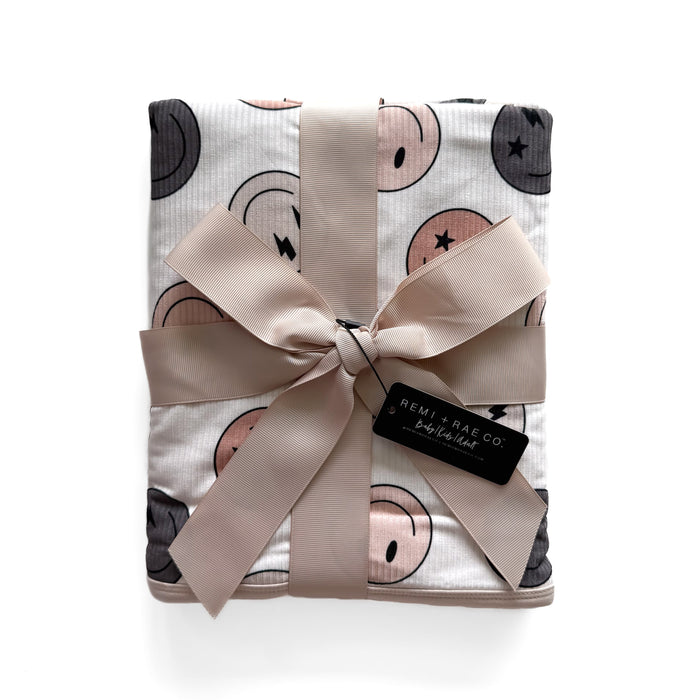 Baby blanket with smiley face pattern