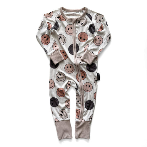 Baby onesie with smiley face pattern on a white background