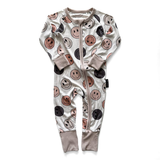 Baby onesie with smiley face pattern on a white background
