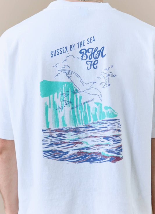 Close-up of the 'Sussex by the Sea' graphic on the back of the white Percival x Brighton & Hove Albion F.C. t-shirt.