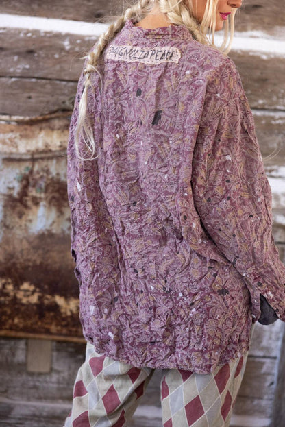 Magnolia Pearl artisan floral jacket with whimsical vintage style, worn by woman in braided hair