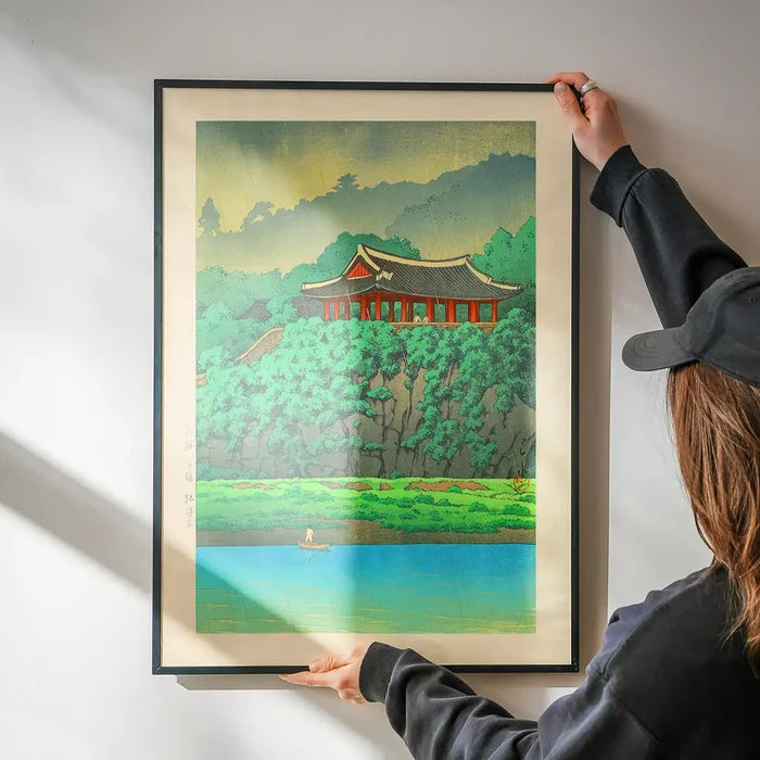 Botan Dai at Ping-yang, Korea Print by Hasui Kawase being hung on a wall in a black frame