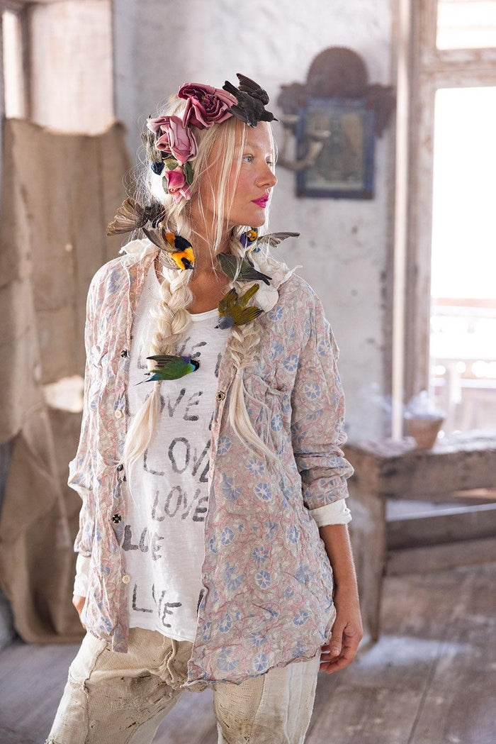 Woman in Magnolia Pearl vintage artisan clothing with whimsical floral and bird accessories
