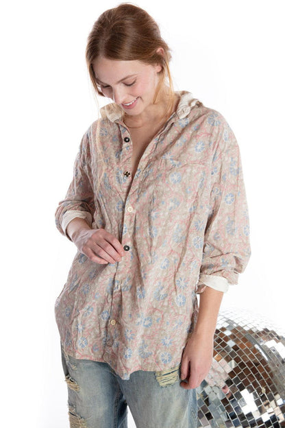 Woman in Magnolia Pearl vintage floral shirt and distressed jeans with disco ball, artisan whimsical clothing