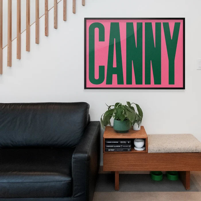Canny Typography Poster Print framed above a living room sofa