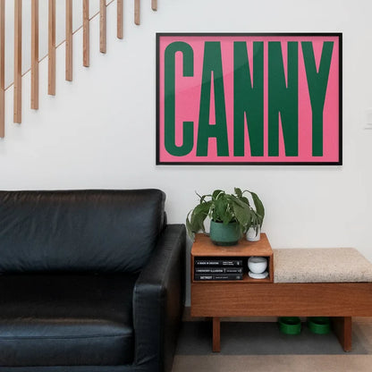 Canny Typography Poster Print framed above a living room sofa