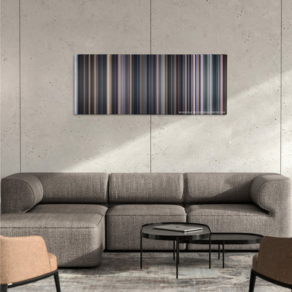 Cinema Paradiso color palette canvas on a concrete wall above a gray sectional sofa