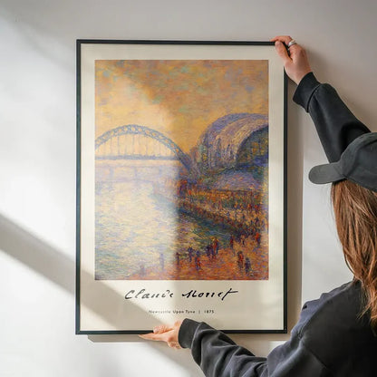 Claude Monet's Painting of Newcastle Quayside Print being hung on a wall in a black frame