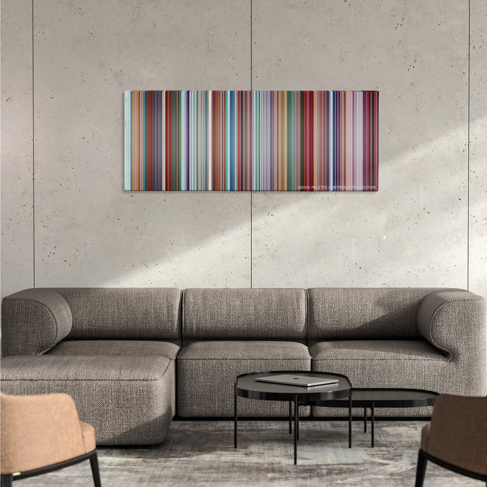 Despicable Me color palette canvas on a concrete wall above a gray sectional sofa