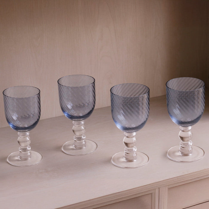 Beatriz Ball Glass French Swirl Wine — Four matching wine glasses on a pale shelf