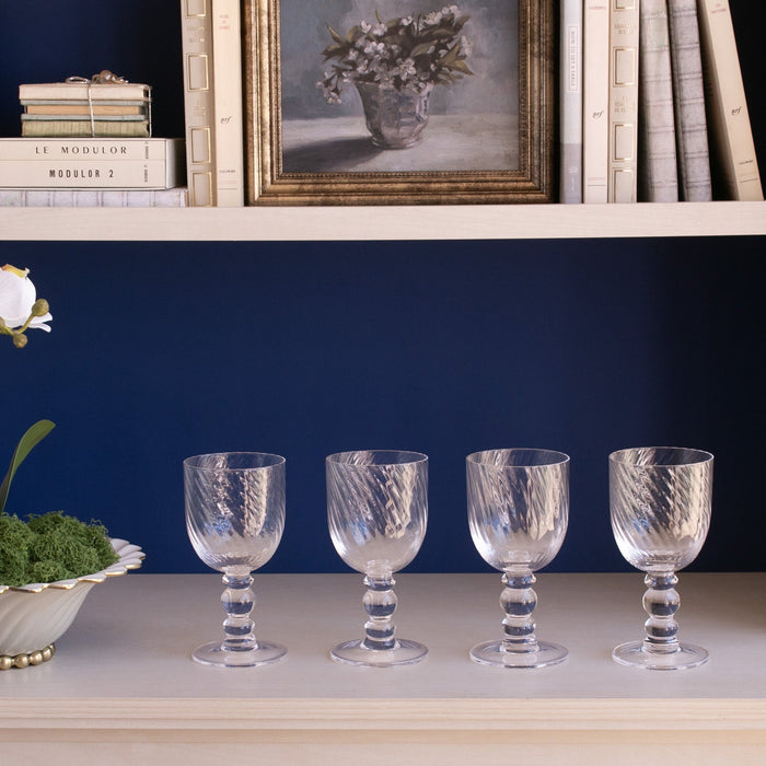 Beatriz Ball Glass French Swirl Wine — Four matching glasses beneath a bookshelf