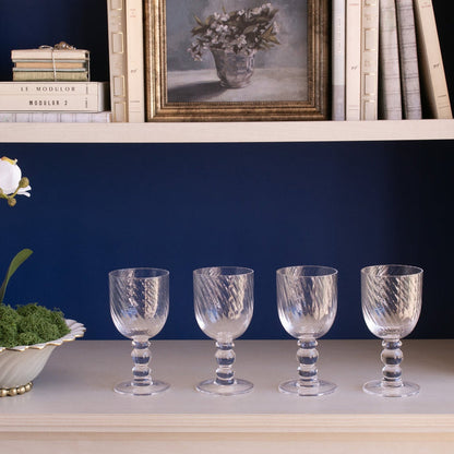 Beatriz Ball Glass French Swirl Wine — Four matching glasses beneath a bookshelf