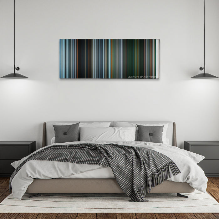 Gravity color palette canvas above a bed, between two black pendant lamps