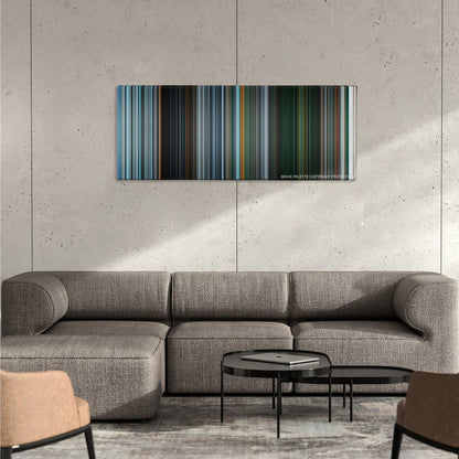 Gravity color palette canvas on a concrete wall above a gray sectional sofa