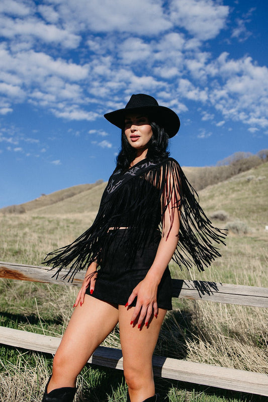 Black fringe western cape styled for gothic cowgirl outfits, country concert fashion, edgy western looks and festival cowgirl style from Sand + Charcoal Boutique.