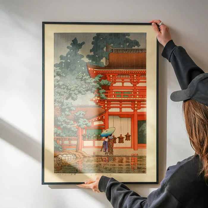Kasuga Shrine in Nara Print by Hasui Kawase being hung on a wall in a black frame