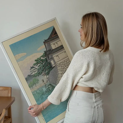 Kikyomon Gate Print by Hasui Kawase held up against a living room wall
