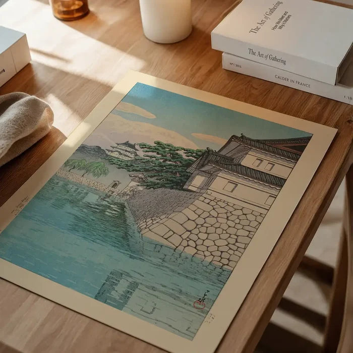 Kikyomon Gate Print by Hasui Kawase, Japanese woodblock print unframed on a home office desk