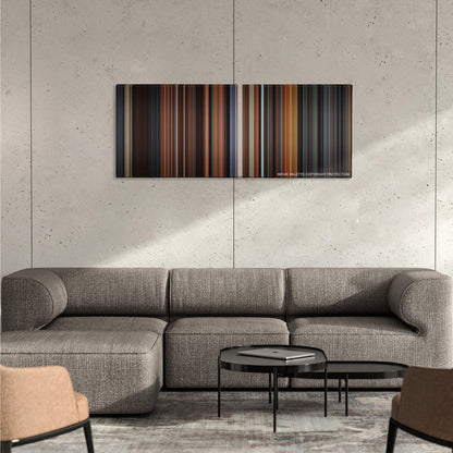 Little Women color palette canvas on a concrete wall above a gray sectional sofa