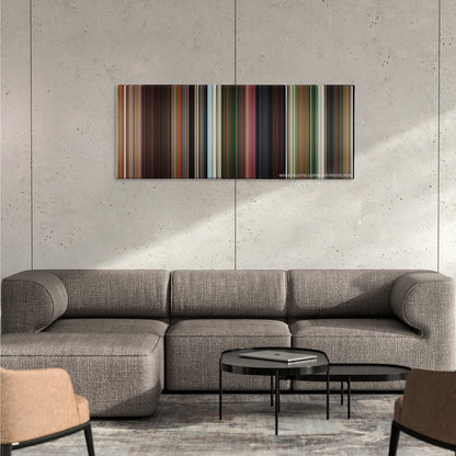 Madagascar color palette canvas on a concrete wall above a gray sectional sofa