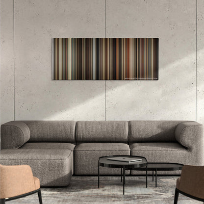 Milk color palette canvas on a concrete wall above a gray sectional sofa