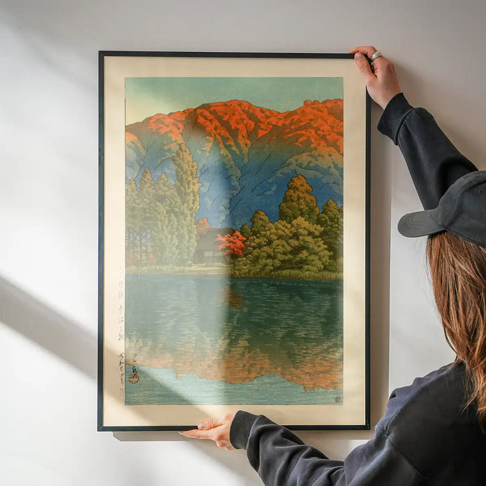 Morning at Ao Marsh, Ura Heights Print by Hasui Kawase being hung on a wall in a black frame