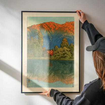 Morning at Ao Marsh, Ura Heights Print by Hasui Kawase being hung on a wall in a black frame