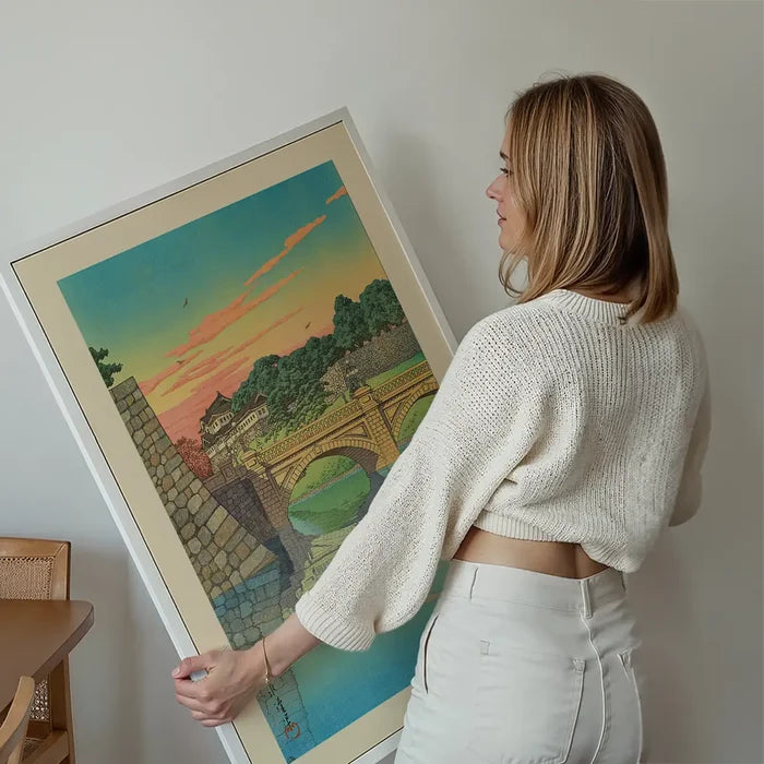 Morning at Niju Bridge Print by Hasui Kawase held up against a living room wall