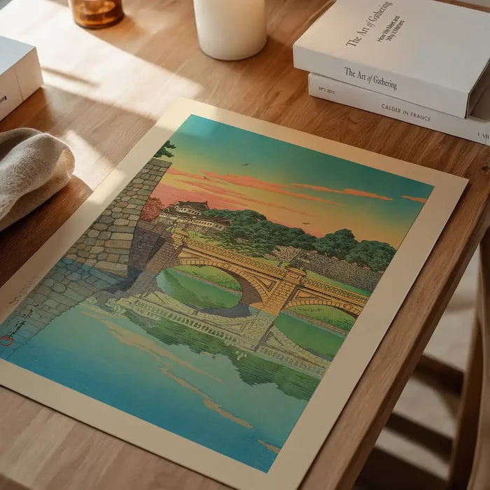 Morning at Niju Bridge Print by Hasui Kawase, Japanese woodblock print unframed on a home office desk