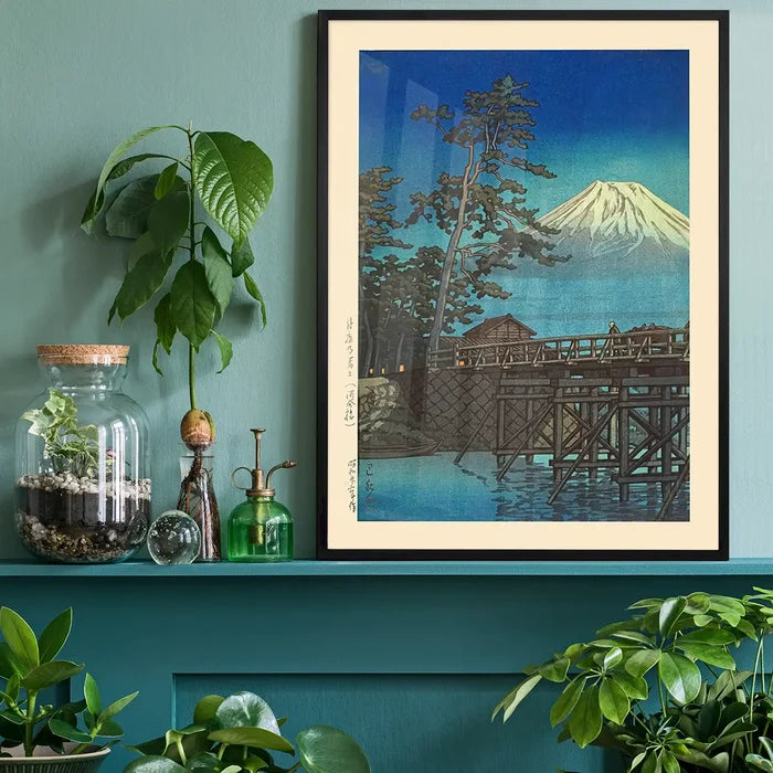 Mt. Fuji in Moonlight and Kawaibashi Bridge Print by Hasui Kawase black framed on a living room shelf