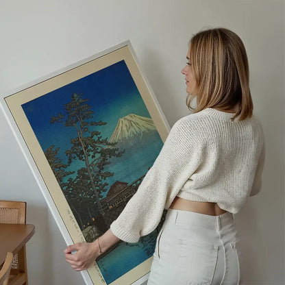 Mt. Fuji in Moonlight and Kawaibashi Bridge Print by Hasui Kawase held up against a living room wall