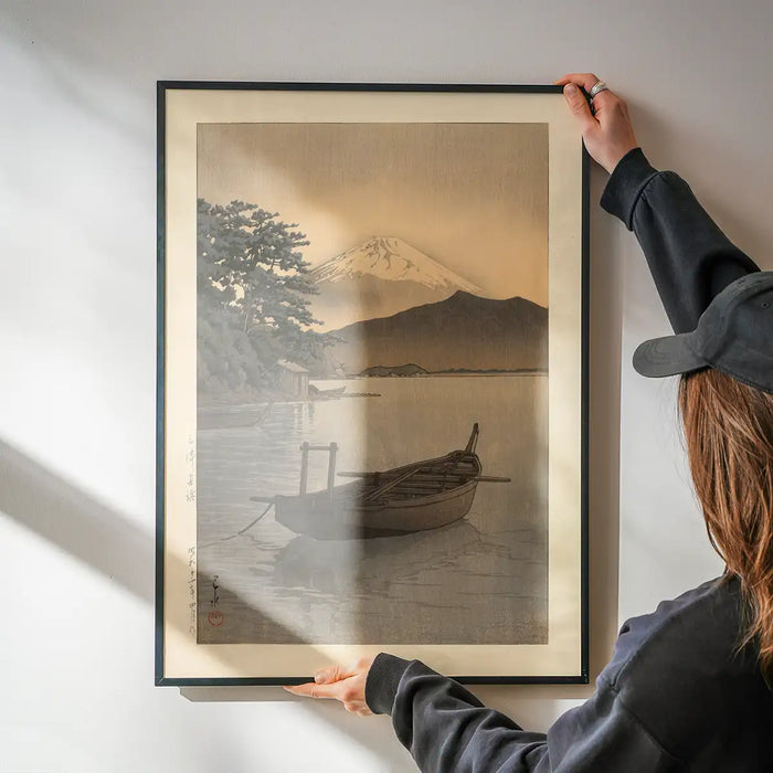 Nagahama Beach in Mito Print by Hasui Kawase being hung on a wall in a black frame