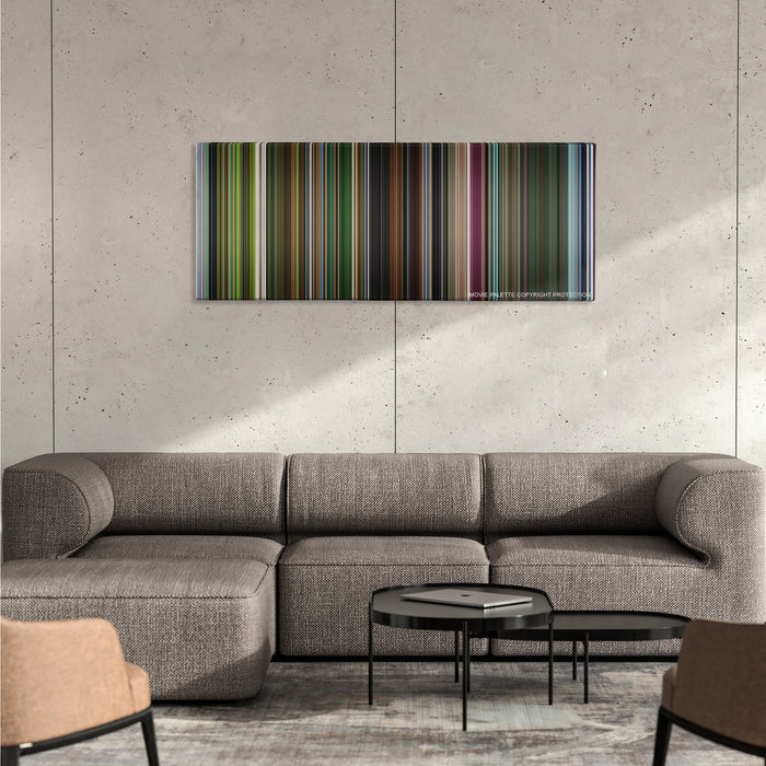 Oldboy color palette canvas on a concrete wall above a gray sectional sofa