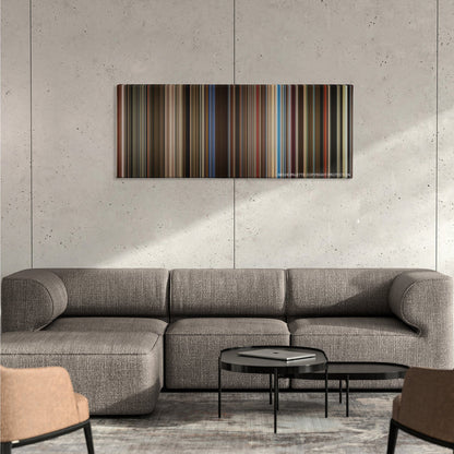 Rocketman color palette canvas on a concrete wall above a gray sectional sofa