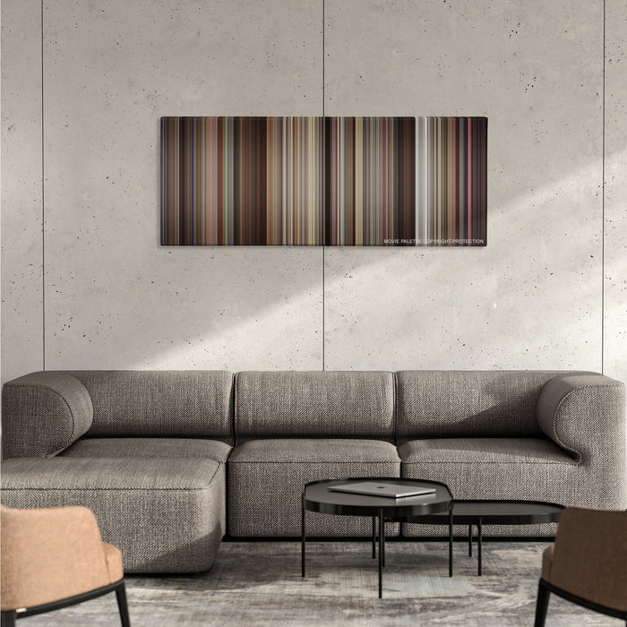 Rushmore color palette canvas on a concrete wall above a gray sectional sofa