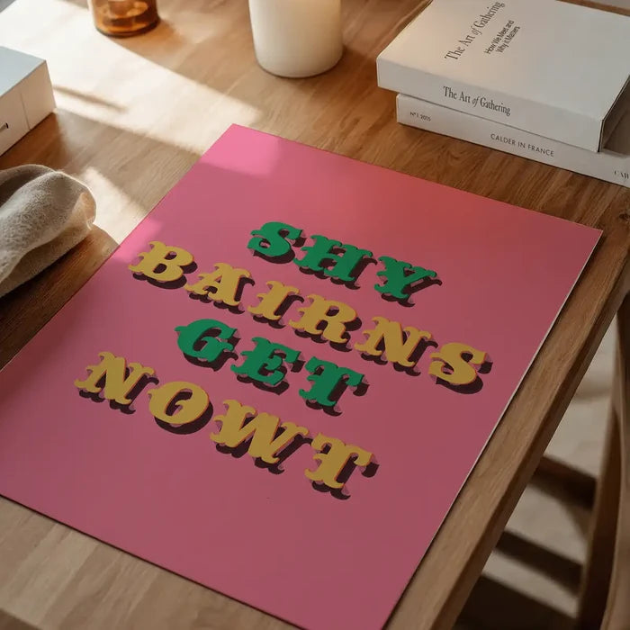 Shy Bairns Quote Print Pink And Green unframed on a home office desk