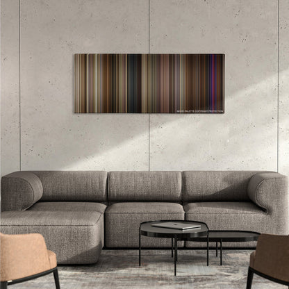 Silver Linings Playbook color palette canvas on a concrete wall above a gray sectional sofa