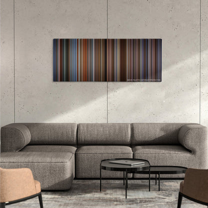 The Family Man color palette canvas on a concrete wall above a gray sectional sofa