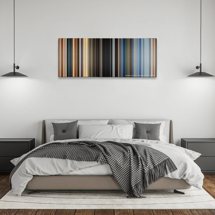 The Old Guard color palette canvas above a bed, between two black pendant lamps