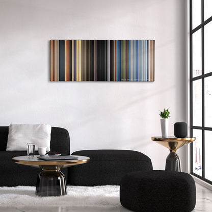 The Old Guard color palette canvas above a black sofa with a gold-topped table